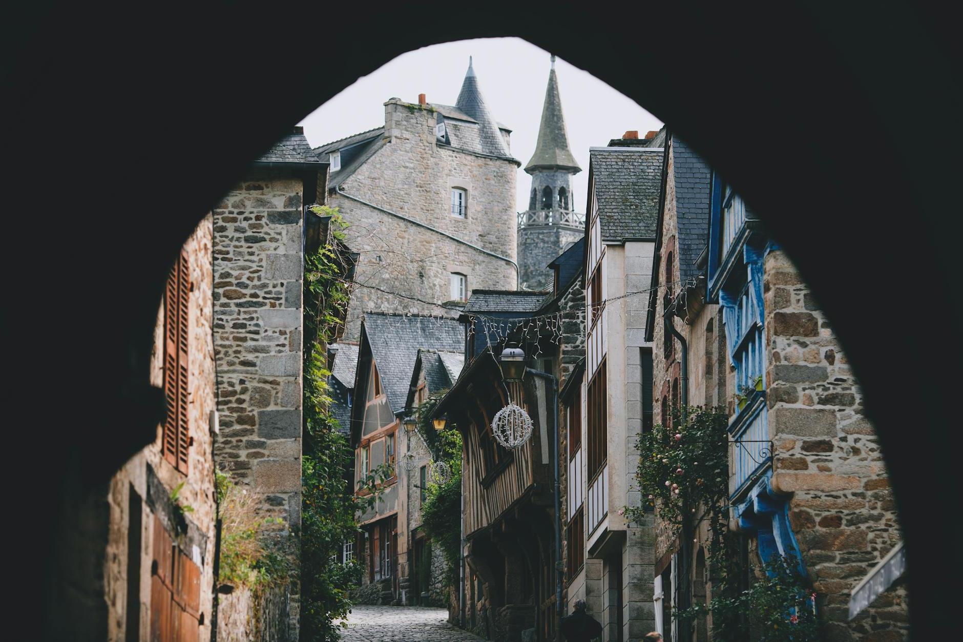 Narrow street of old town with arched passage and typical stone houses