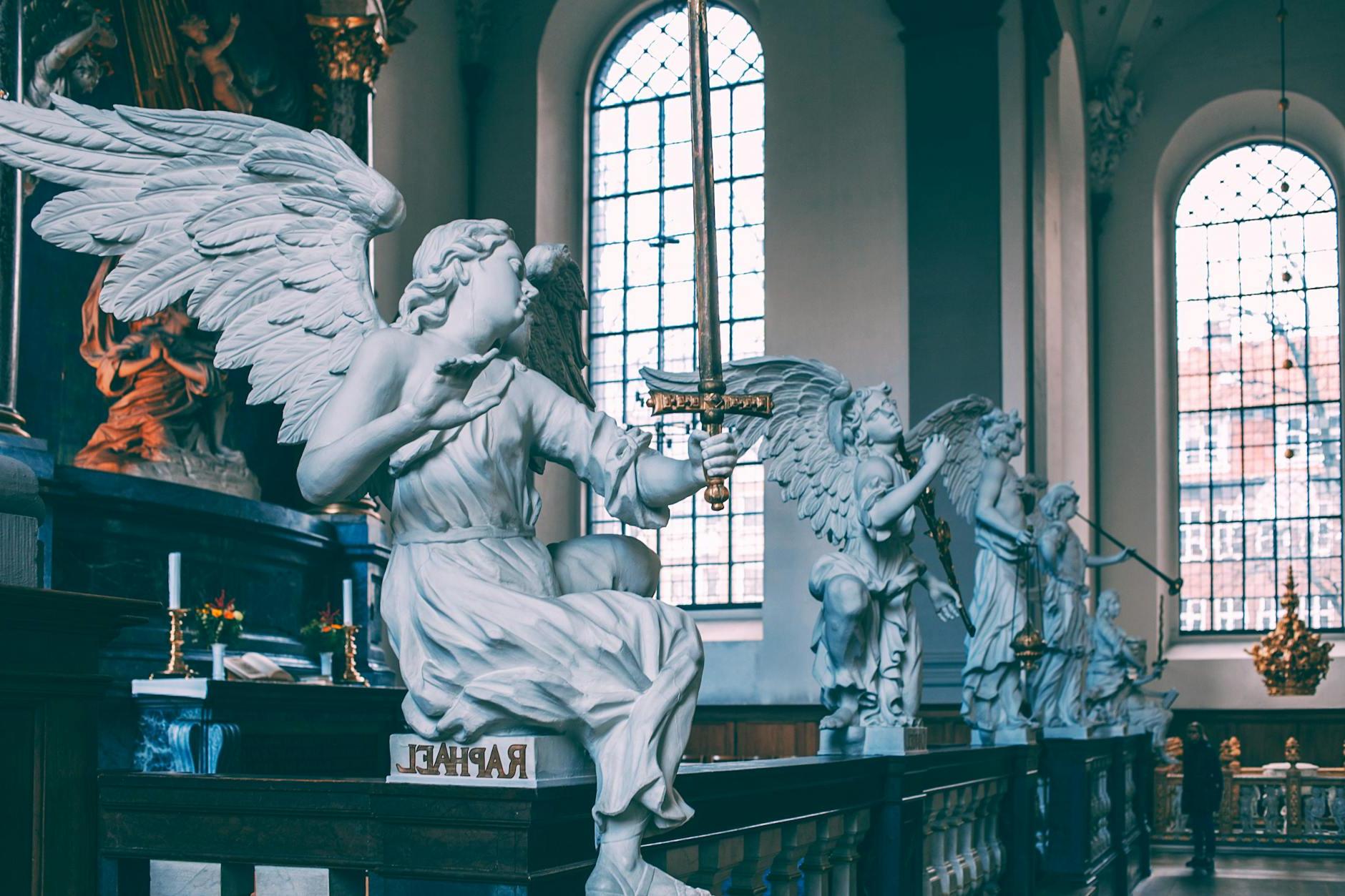 Baroque altarpiece decorated with white angels sculptures on marble railing located in Church of Our Saviour Copenhagen Denmark