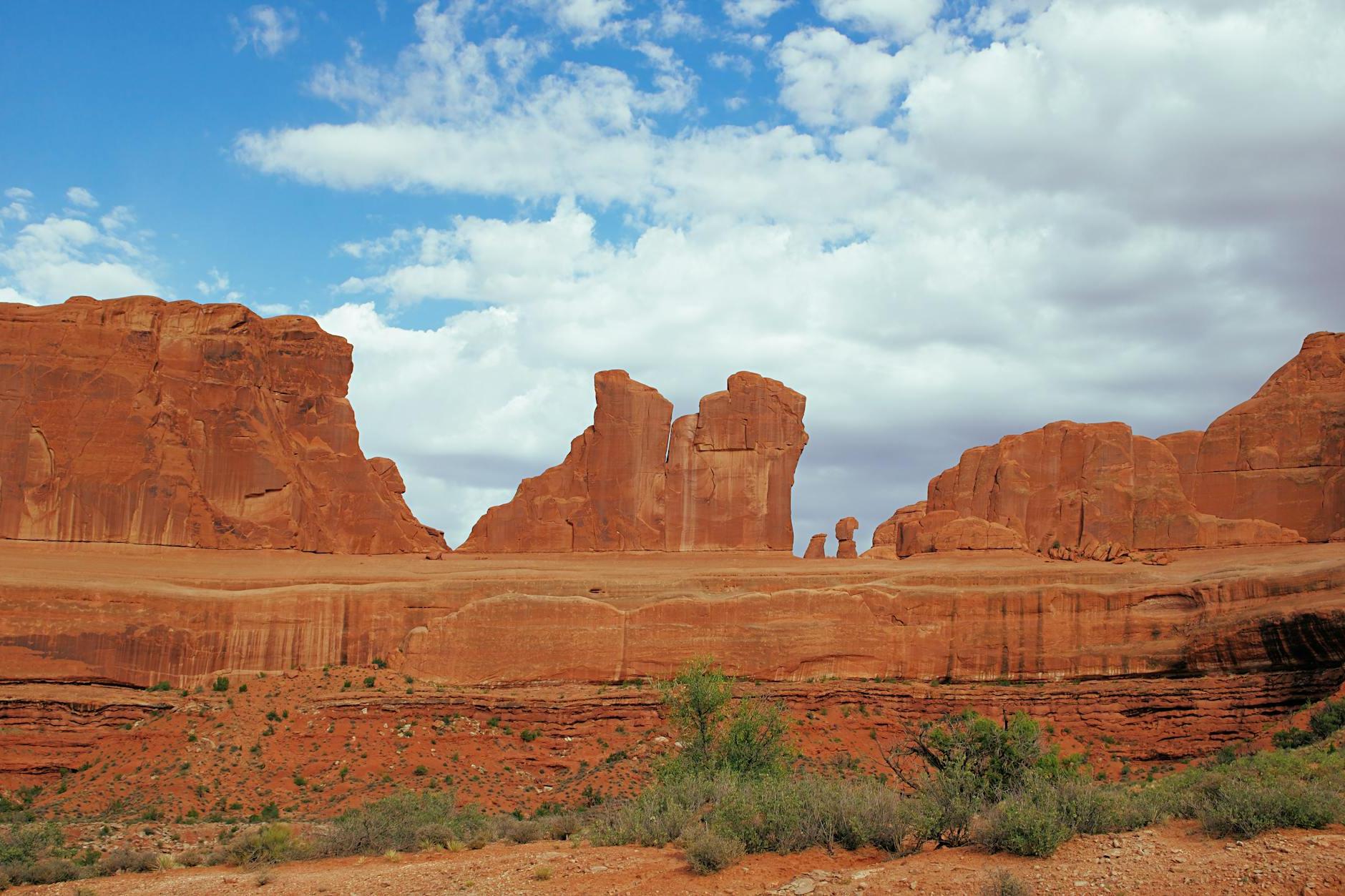 Brown Rock Formation Under White Clouds and Blue Sky