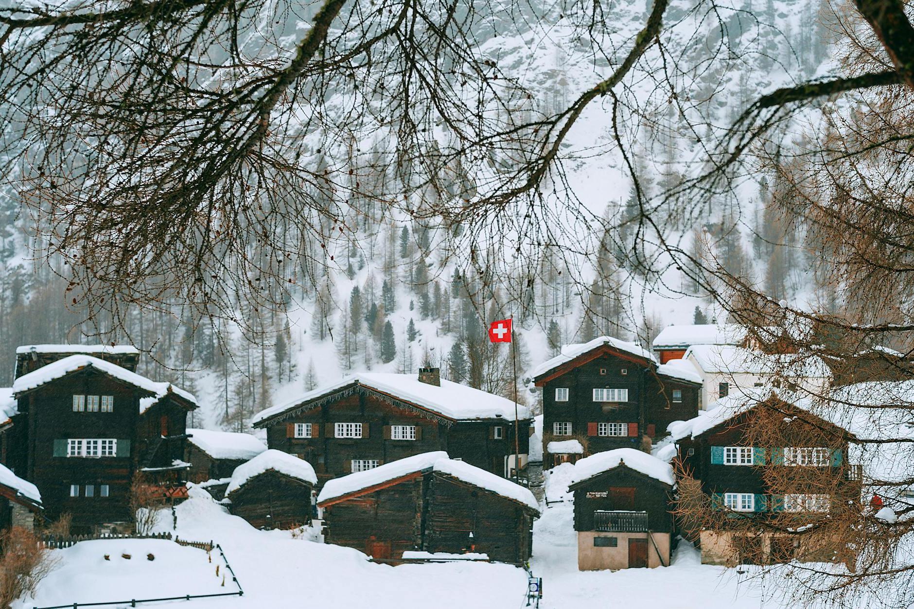 Snowy village houses on hilly terrain