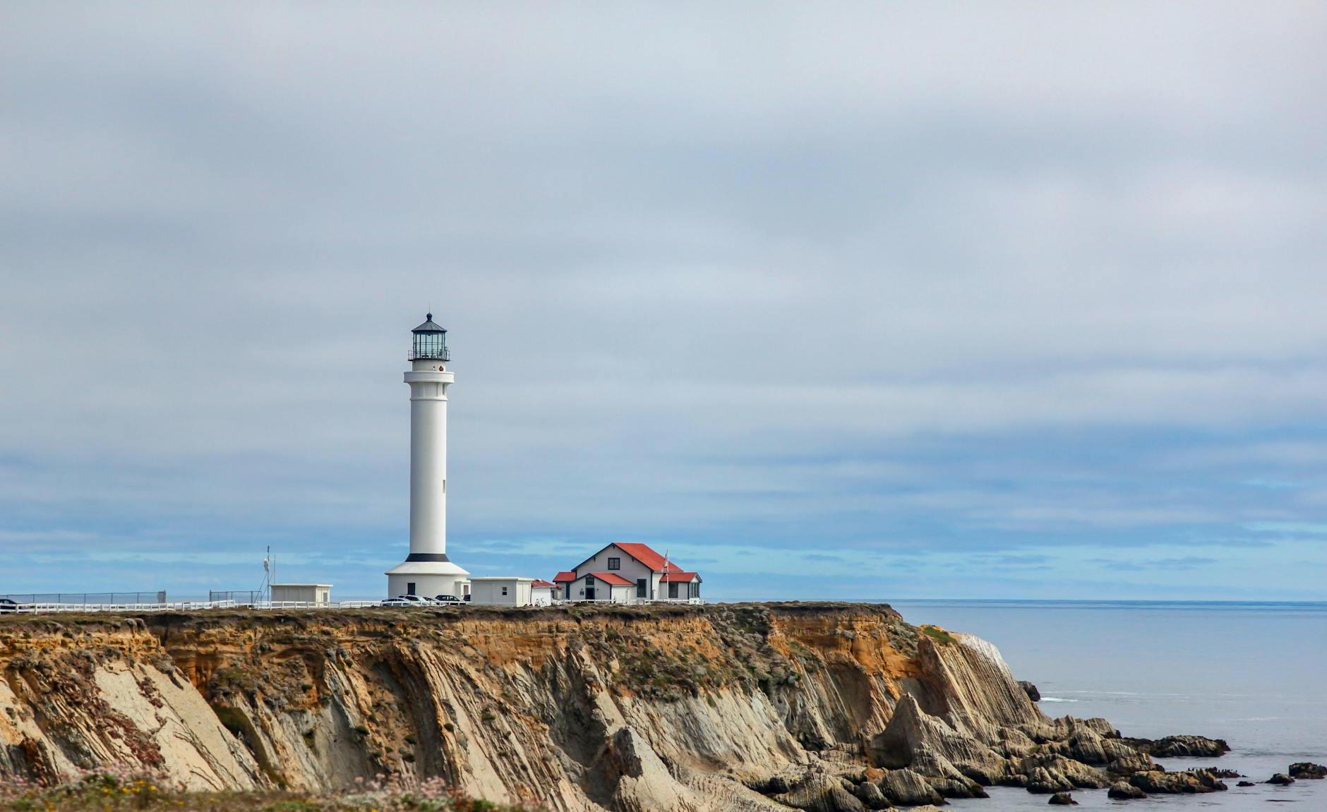 White Lighthouse Near Body of Water