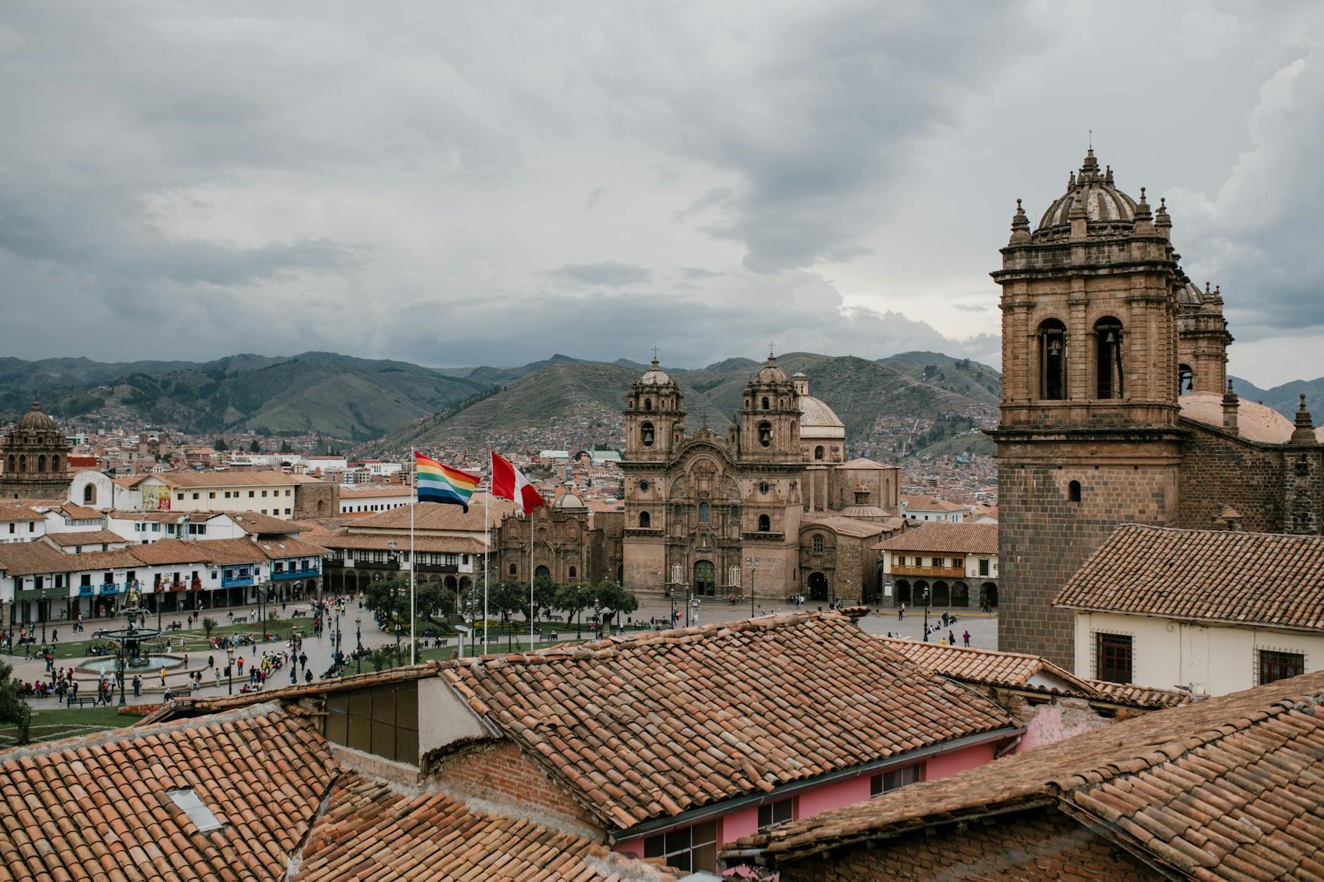 Cityscape of medieval church and houses with old tile roof in Cusco Peru