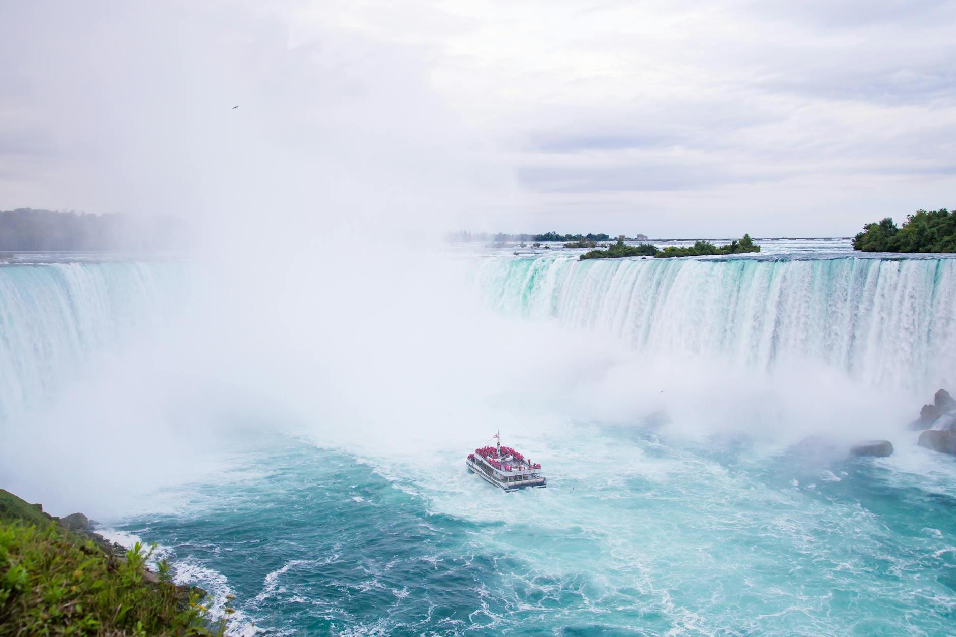 Splashing Niagara Falls and yacht sailing on river