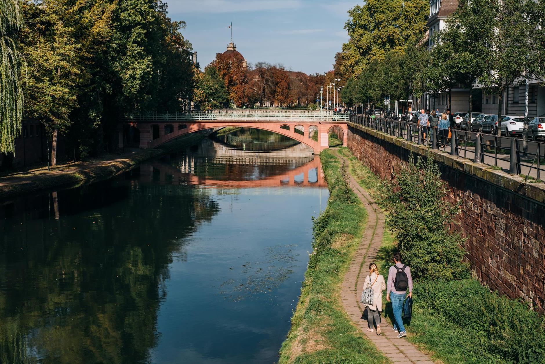 Narrow sidewalk and old building over river