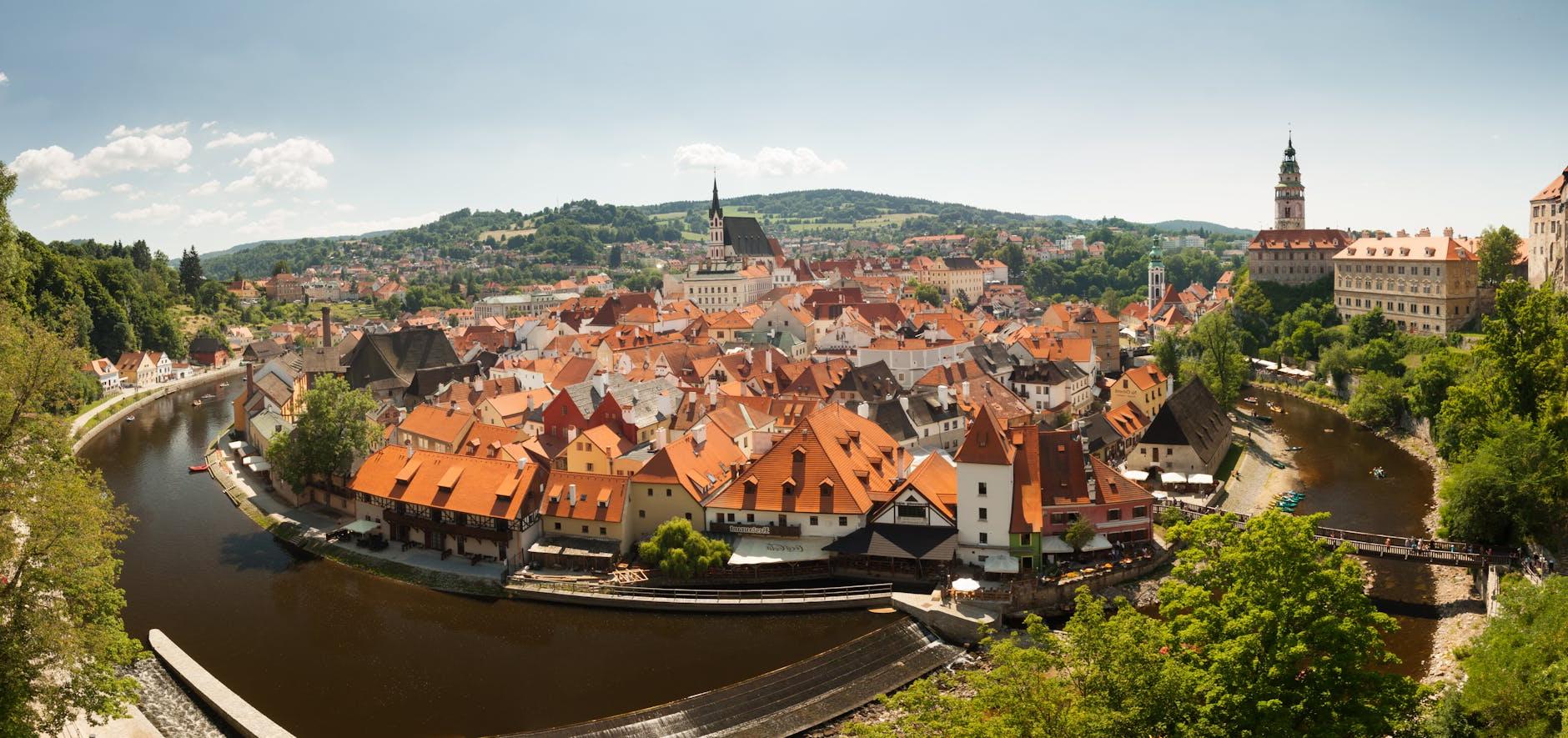 Bird's Eye View Photography of Brown Houses Beside Body of Water