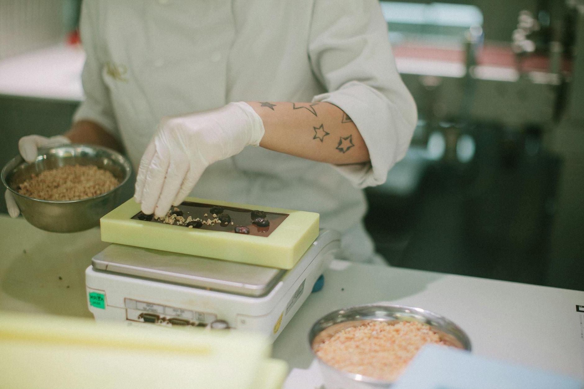 Person in Gloves Making Chocolate at Factory