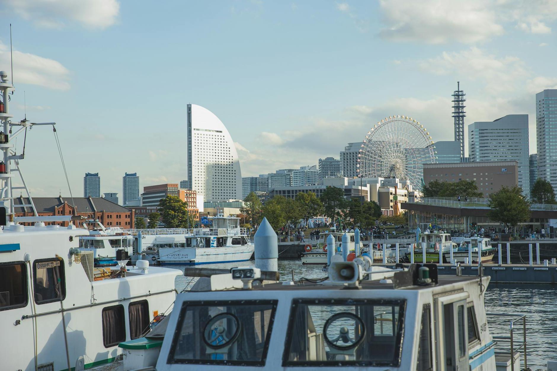 Vessels moored in harbor of modern urban city