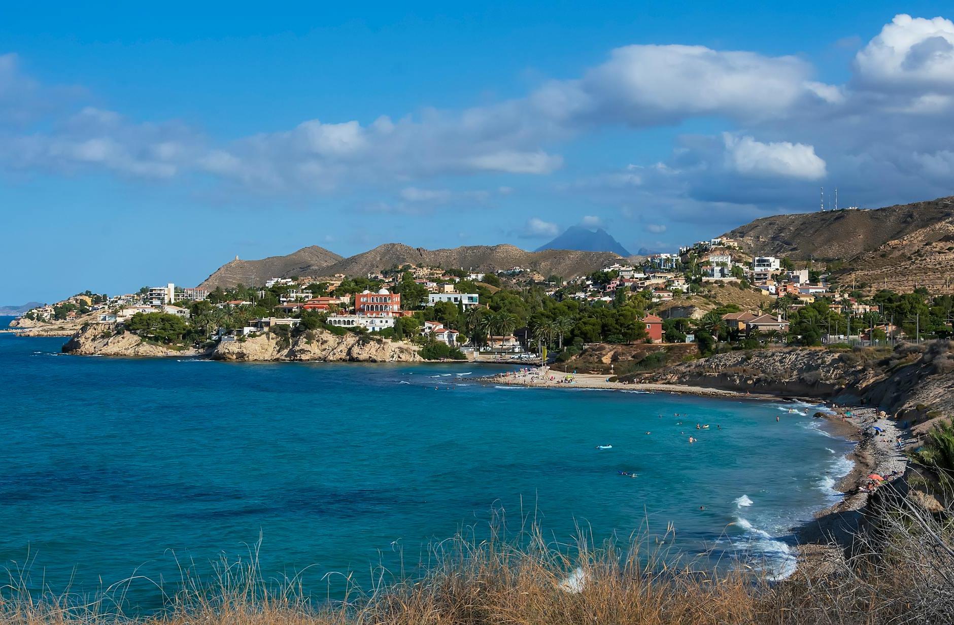 Beautiful Beach Near a Village Under Blue Sky