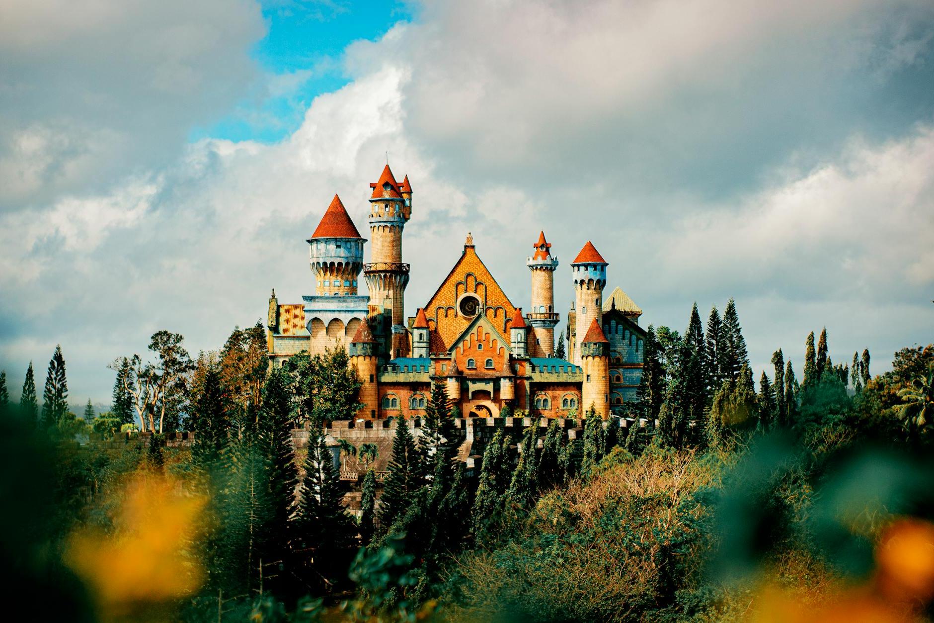 Castle facade in theme park under cloudy sky