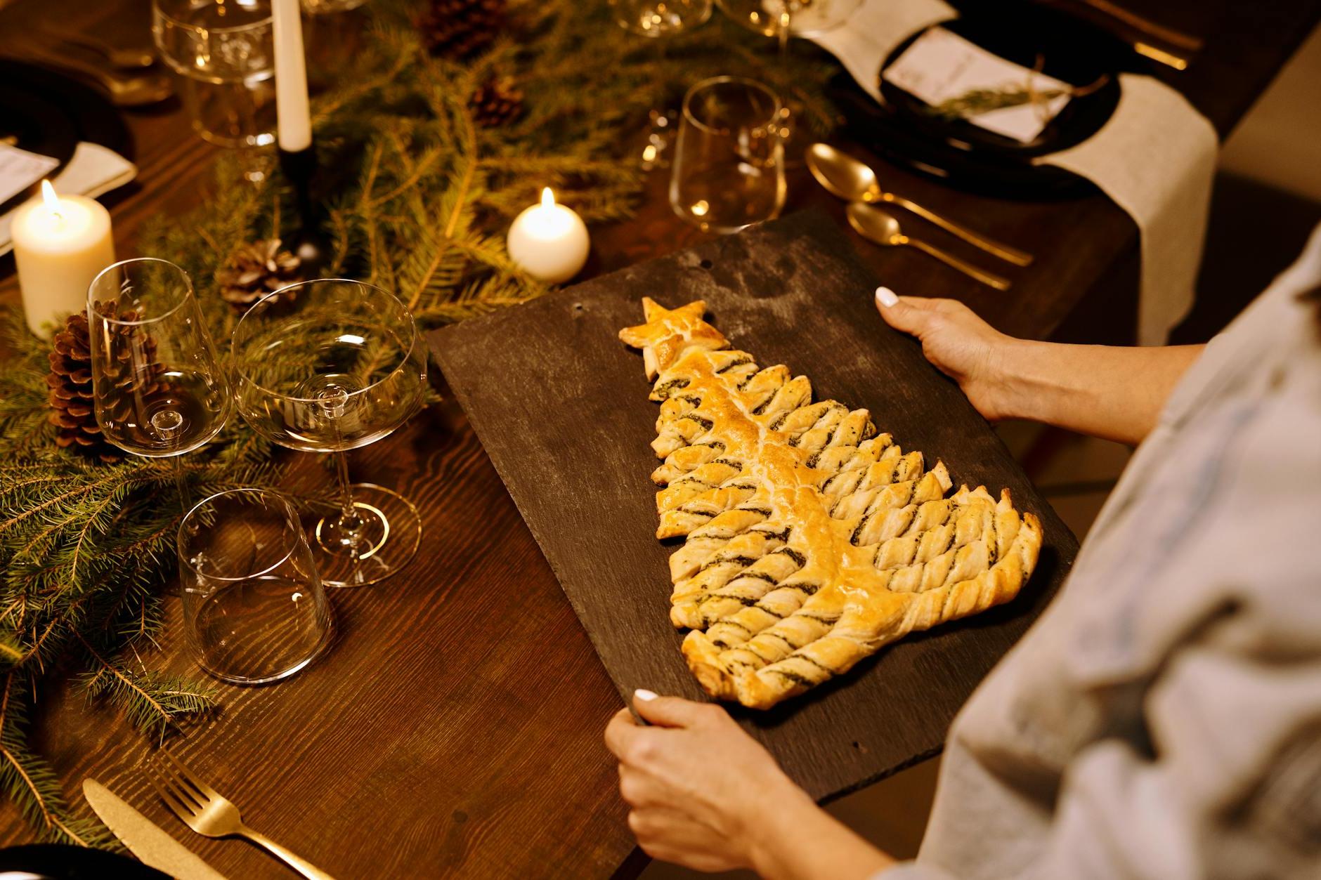 Person Serving a Freshly Baked Bread on a Wooden Tray