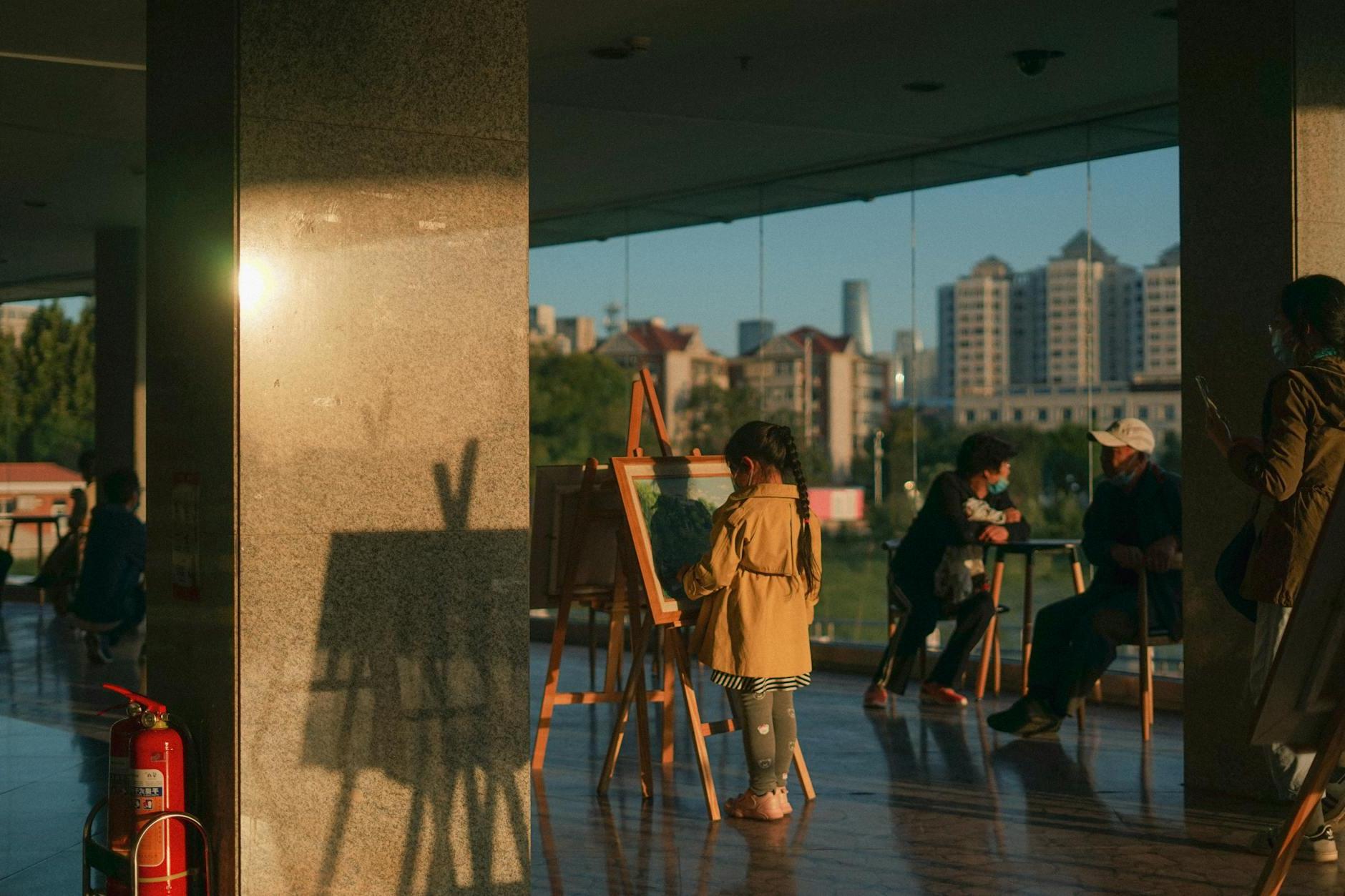 Small Girl Looking at Painting Indoors