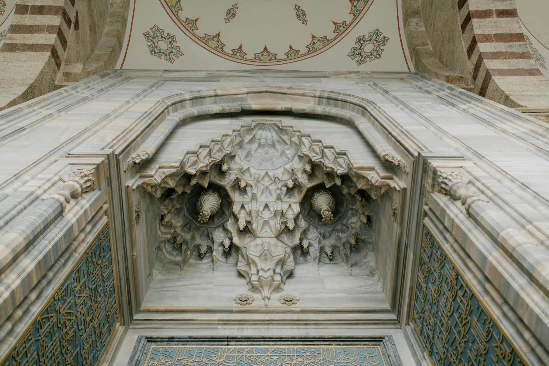 Stone arch and dome in oriental ancient mosque decorated with ornaments