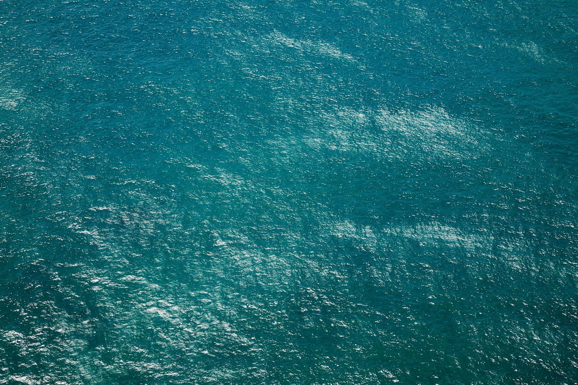 Drone view of rippling azure pure water of sea with little waves running on surface