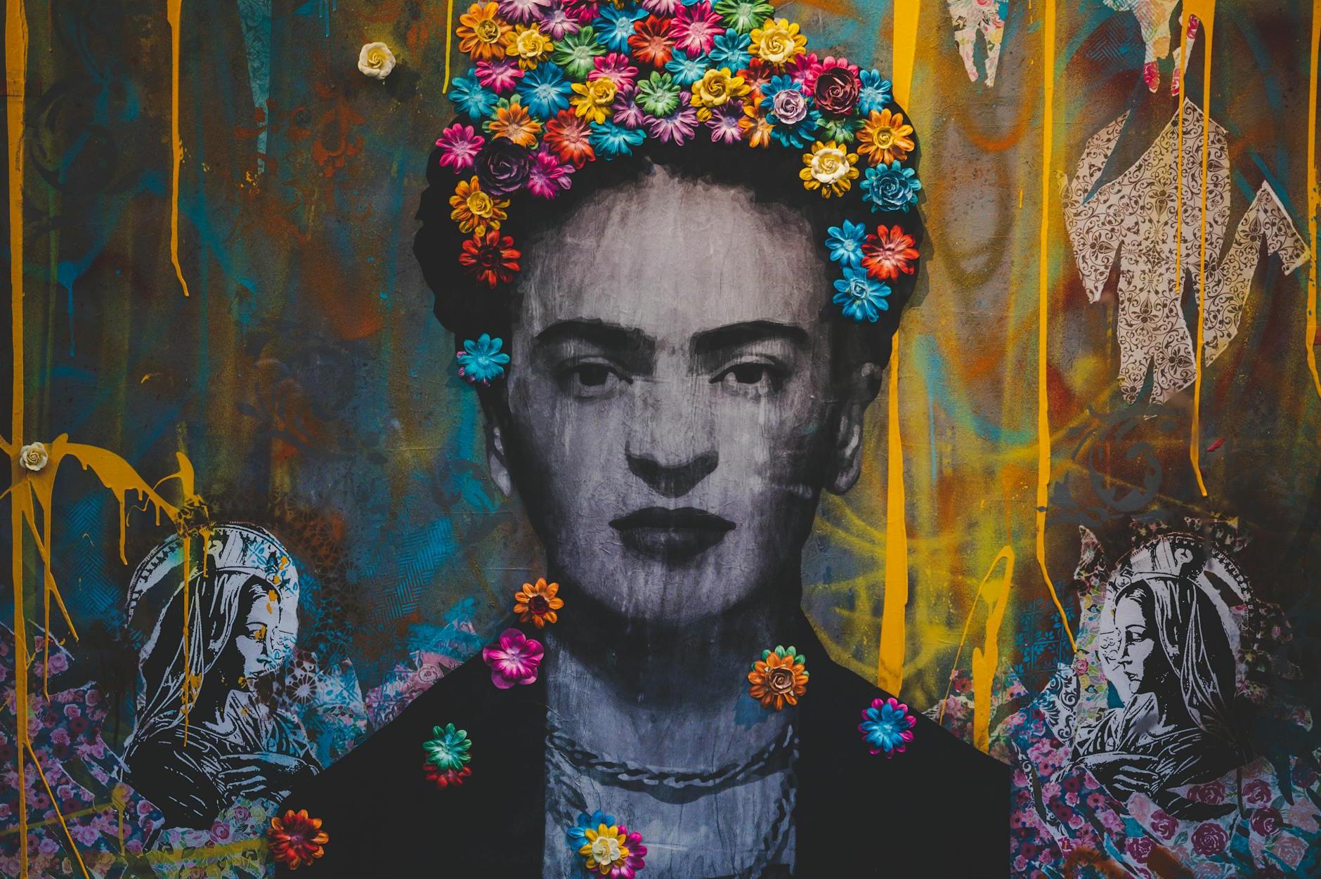 Creative artwork with Frida Kahlo painting decorated with colorful floral headband on graffiti wall