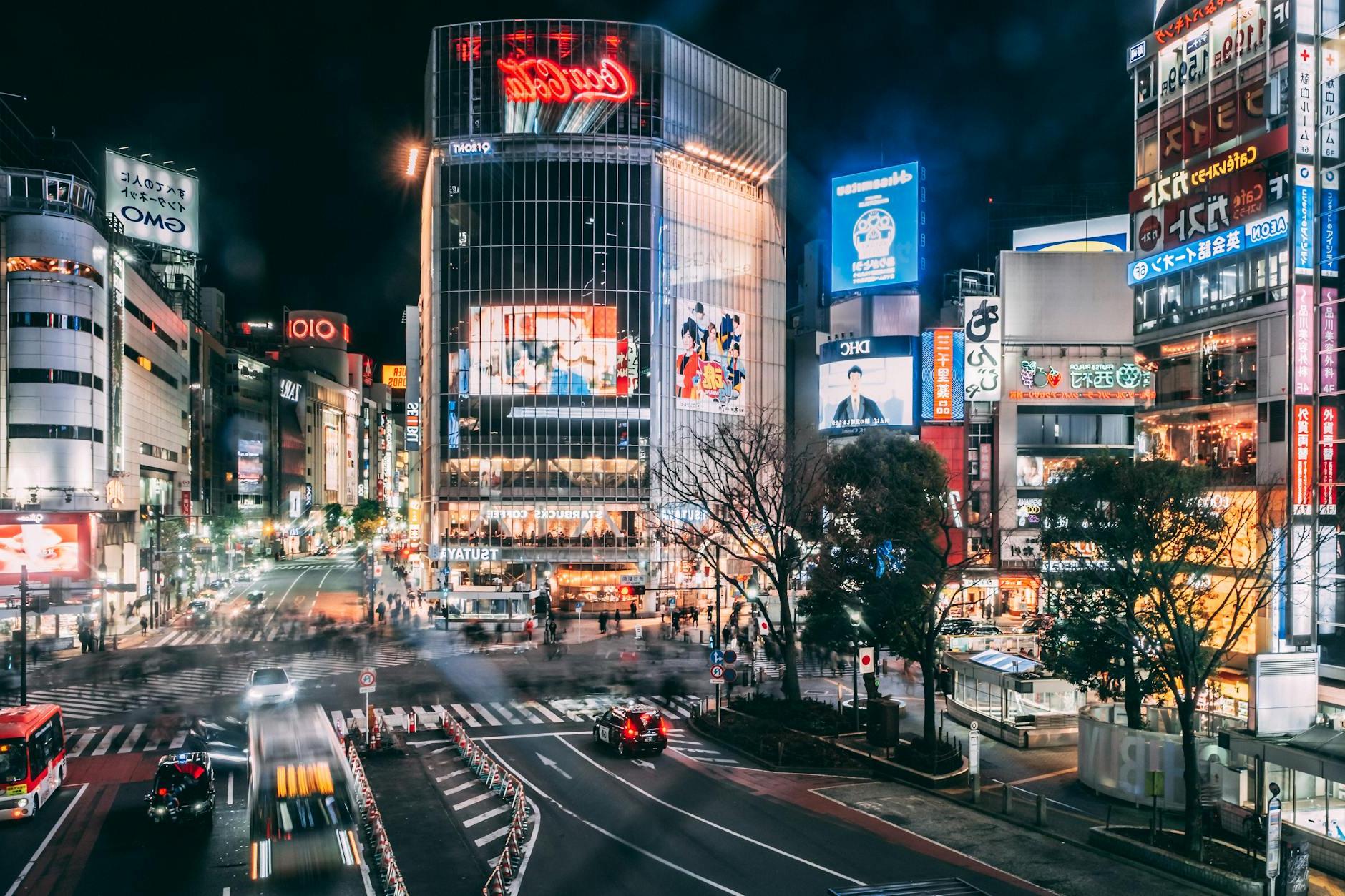 Spectacular scenery of various modern commercial buildings with colorful illumination located in Shibuya district of Tokyo at night