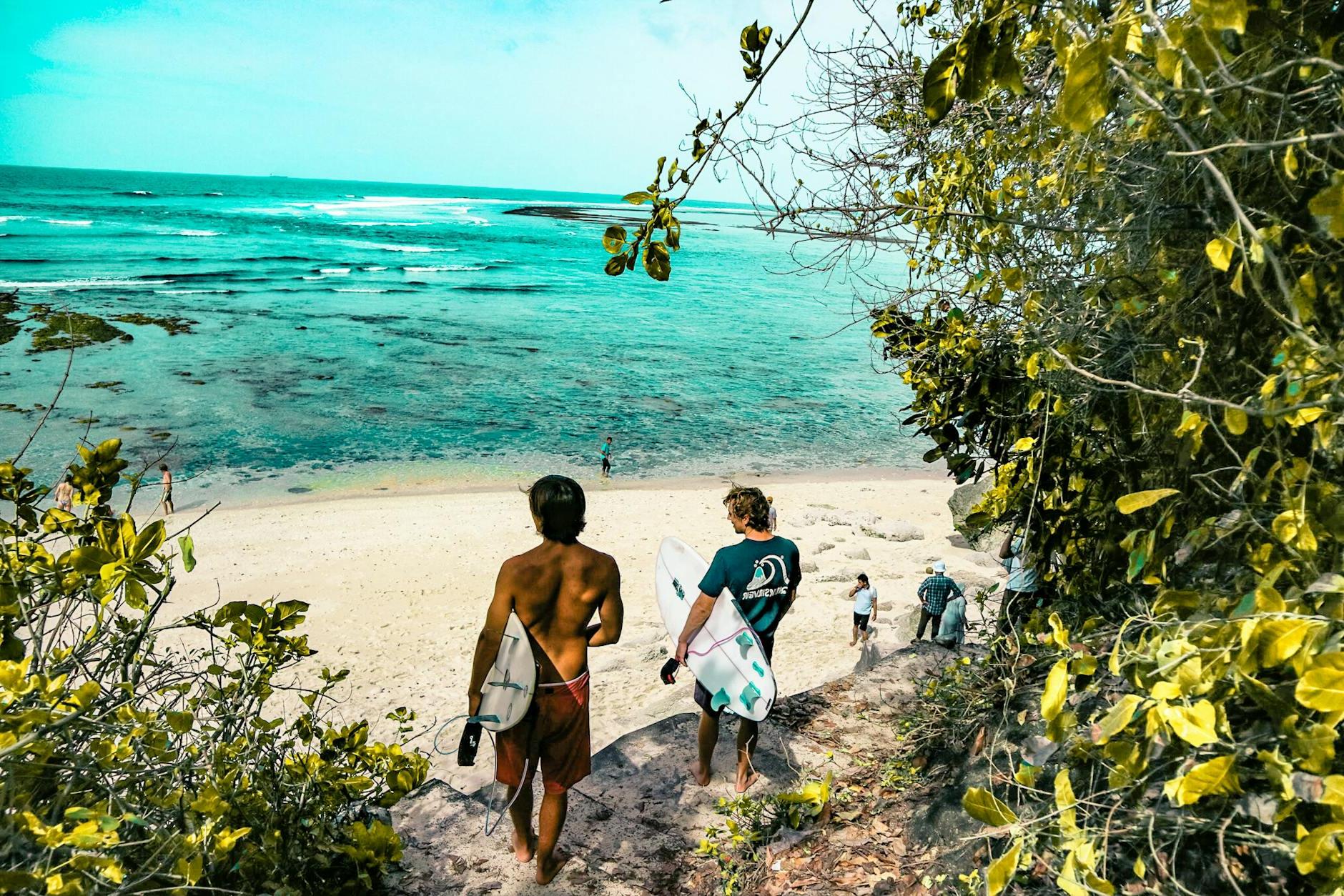 Two Man Holding Surfboards Going to Beach