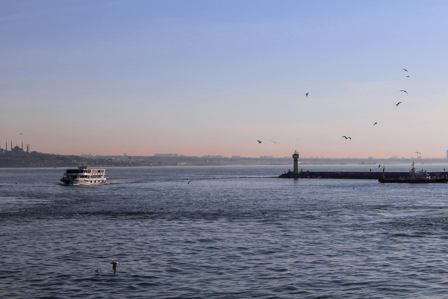 Ship floating on sea near pier