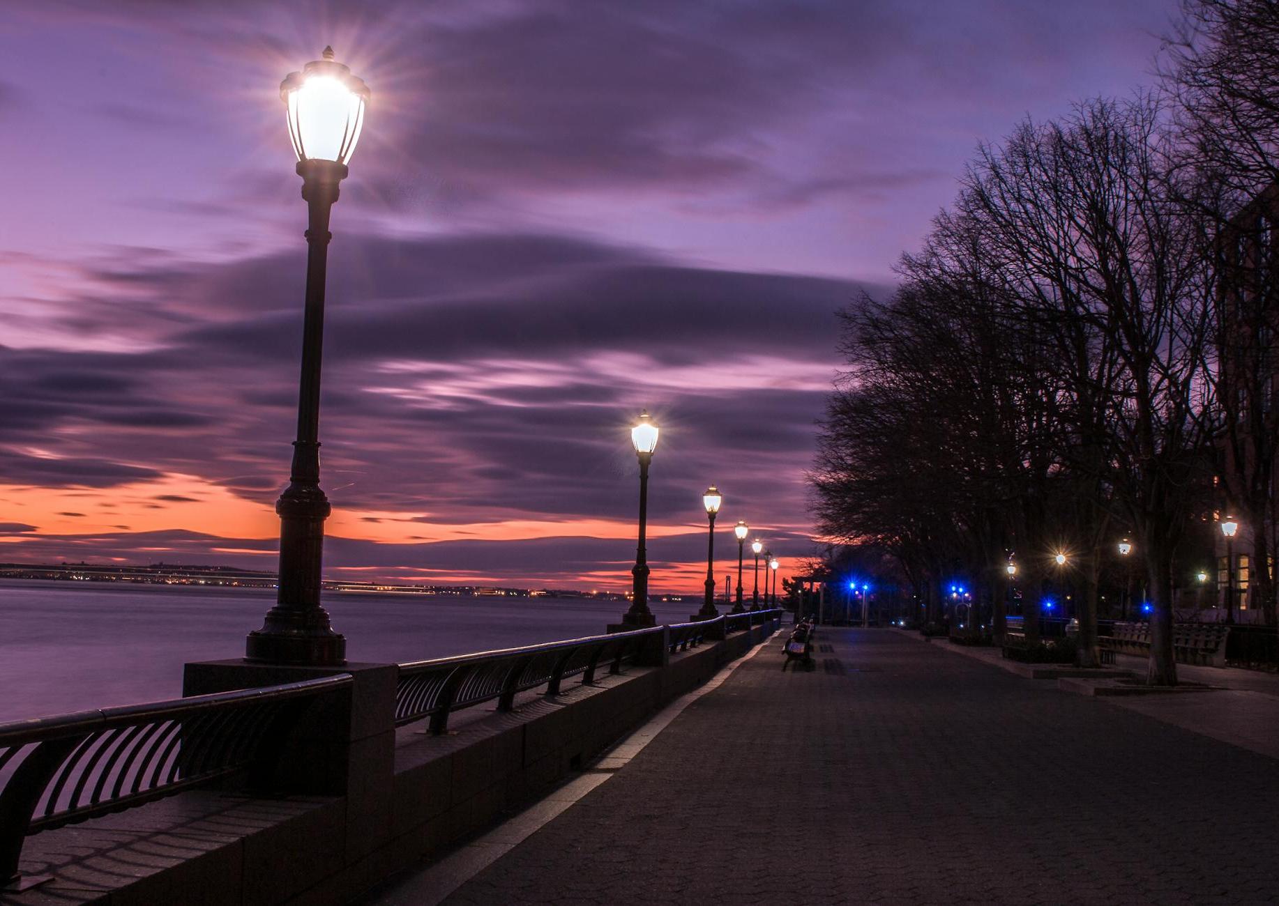 Photography of Turned on Street Lamps Beside Bay during Night Time