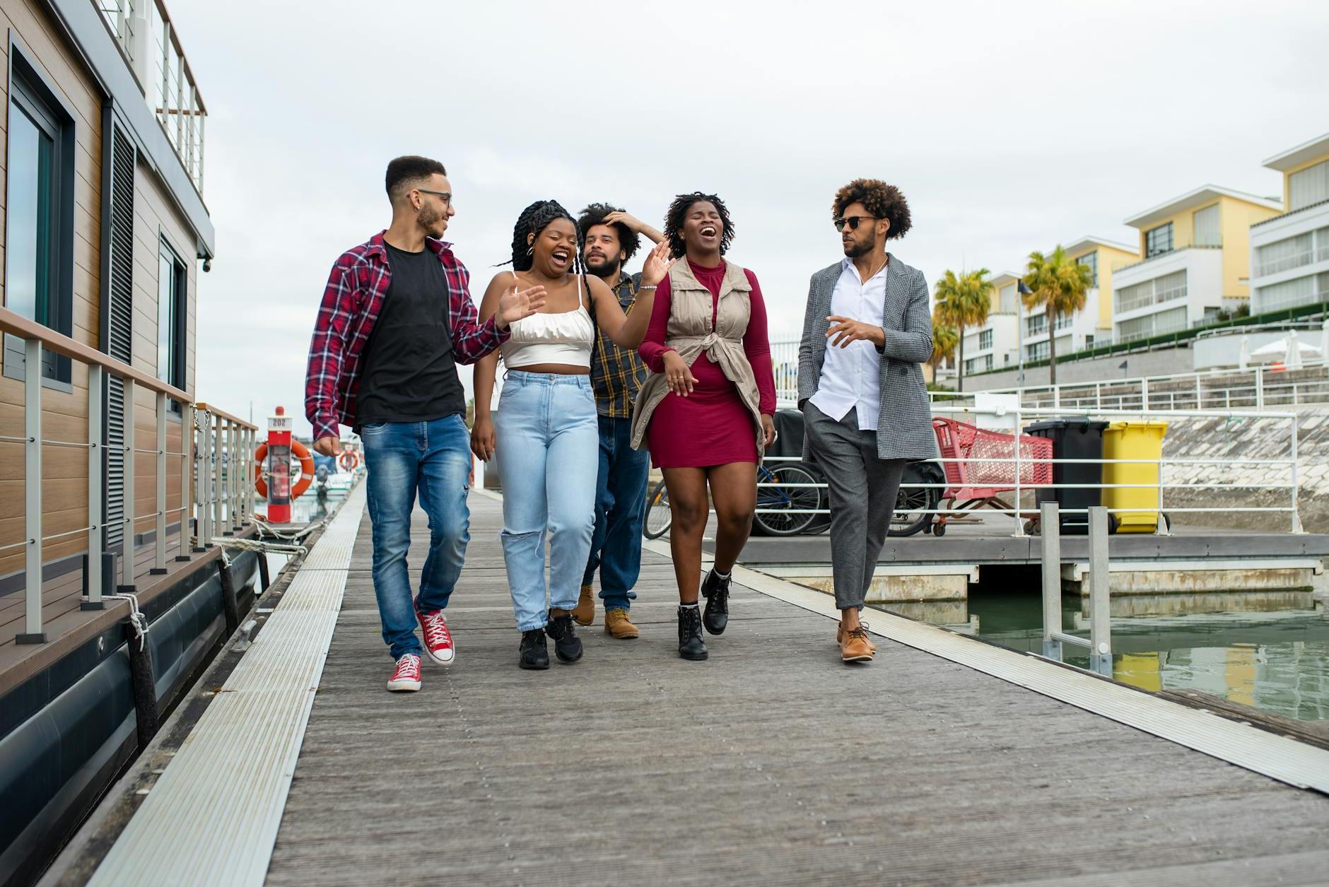 Group of Happy People Walking on Boardwalk