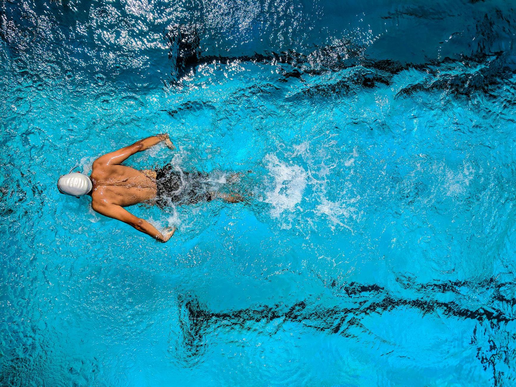 Person Swimming on Body of Water