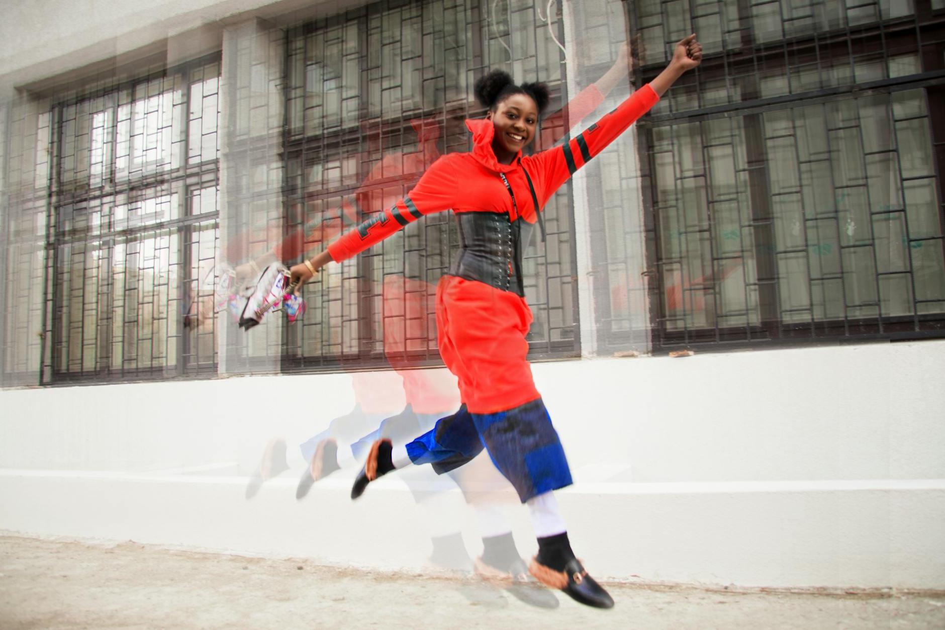 Woman Wearing Red Dress Jumping