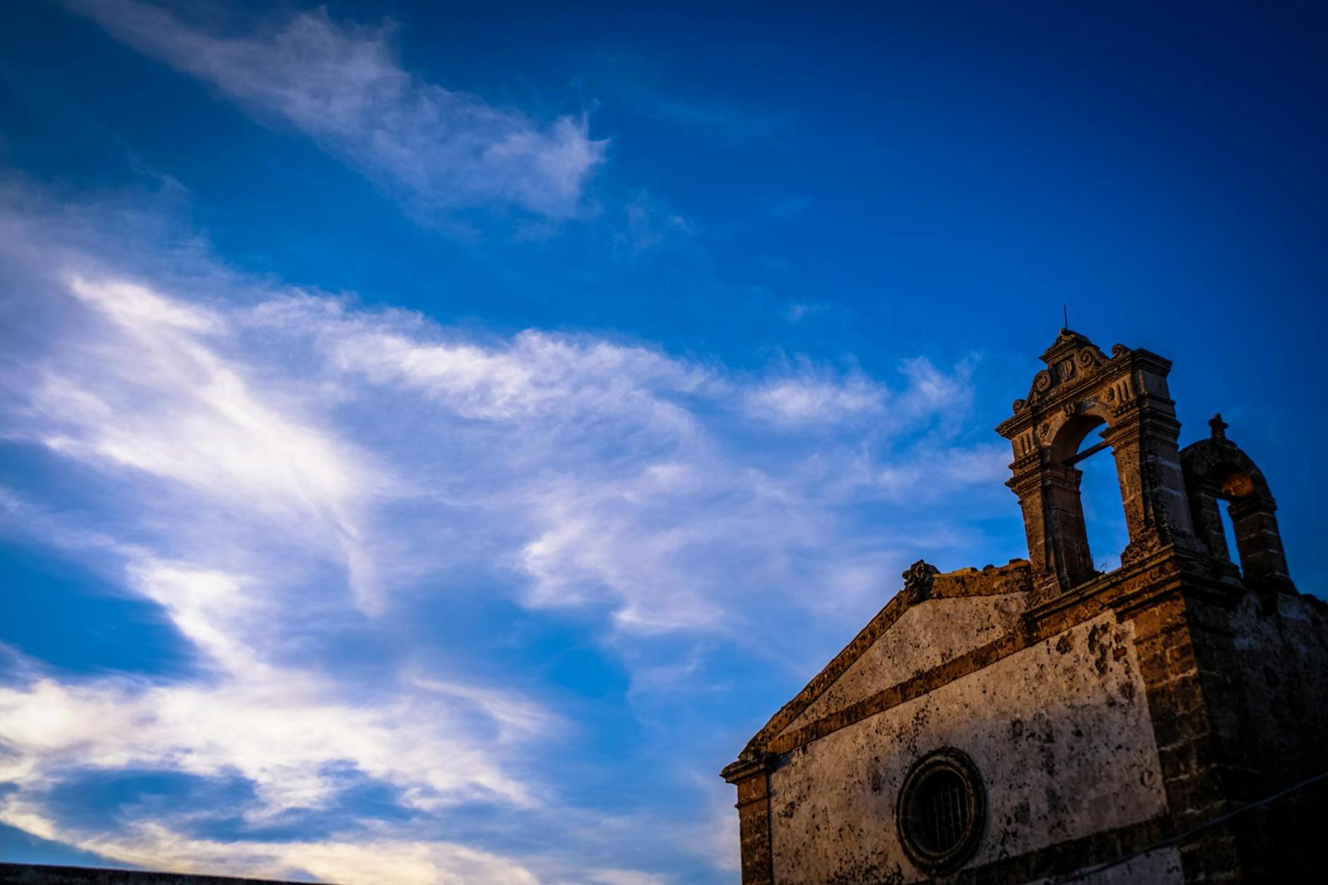 Brown Concrete Chapel Under Cloudy Blue Sky